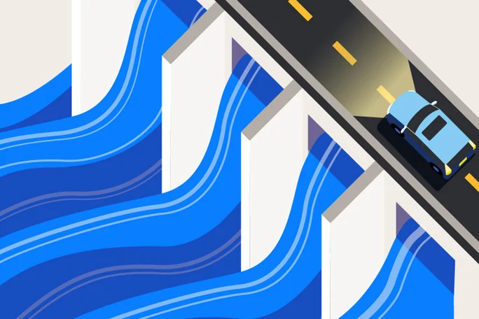 A car drives over a bridge spanning a river, surrounded by scenic landscapes.
